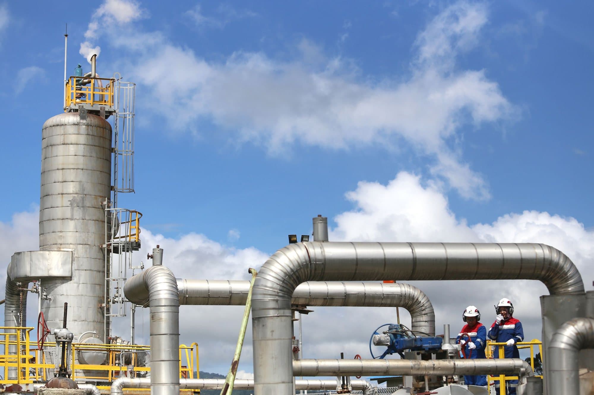 Engineers checking pipework at a blending plant